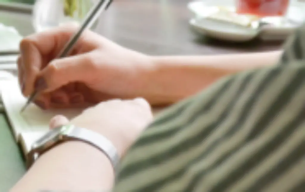 Mädchen schreibt sich etwas in ein Heft hinein. Foto: Jonas Walzberg